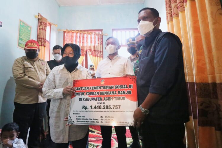 Menteri Sosial Tri Rismaharini saat menyerahkan bantuan terdampak bencana banjir di Aceh Timur