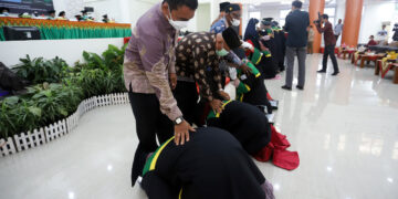 Lulusan UIN Ar Raniry Banda Aceh bersimpuh dan mencium kaki kedua orang tua usai wisuda, Rabu (9/2) di Auditorium Prof Ali Hasjmy Kopelma Darussalam