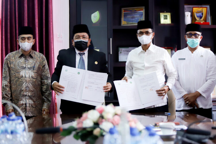 Rektor UIN Ar-Raniry Prof Warul Walidin dan Bupati Bireuen Muzakkar A Gani menandatangani naskah kerja sama antara kedua lembaga, Jum'at (11/2)