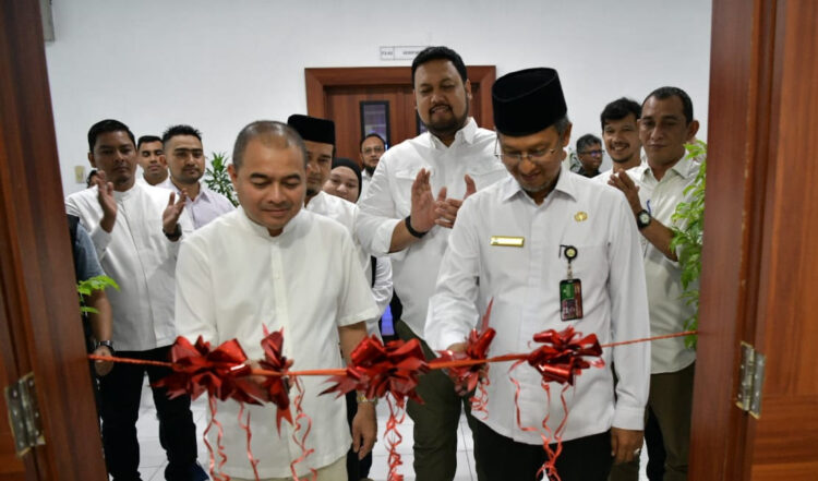 Asisten Administrasi Umum Setda Aceh Dr Iskandar bersama Kepala Inspektorat Aceh Jamaluddin melakukan pengguntikan pita saat meluncurkan Klinik e-Katalog Lokal Aceh di Biro PBJ, Kantor Gubernur Aceh, Jum'at (1/9)