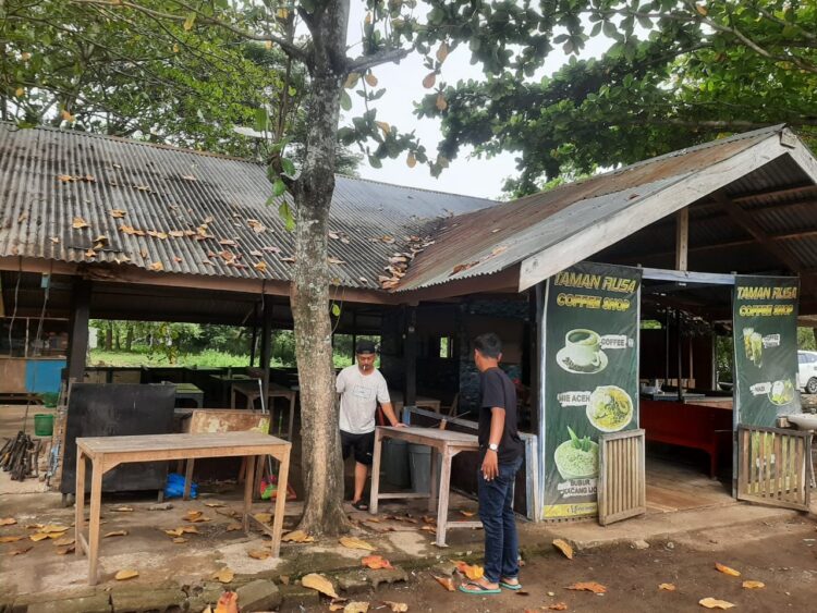 Muhammad Irfan (30) sedang memperbaiki warung kopi miliknya di sekitar venue Paralayang, Gampong Lamtanjong, Kecamatan Suka Makmur, Aceh Besar, Jumat (23/8/2024). Foto: Istimewa