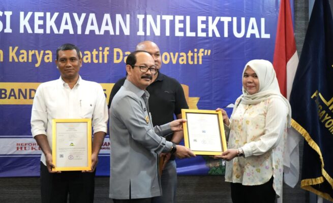 Kakanwil Kemenkum Aceh Meurah Budiman menyerahkan sertifikat merek kepada pelaku usaha di Aceh pada Selasa (6/5) di Hotel Kyriad Muraya, Banda Aceh
